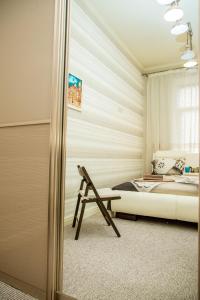 リヴィウにあるApartments in Scandinavian Styleのベッドルーム1室(ベッド1台、椅子付)