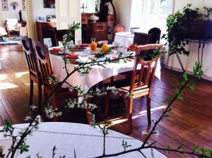 a dining room table with a white tablecloth on it at Château de Penfrat in Gouesnach +8 photos