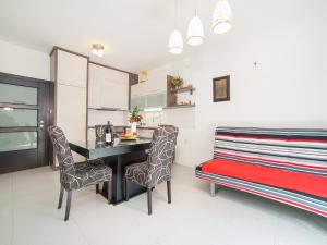a kitchen with a table and chairs and a bed at Apartments Franovic in Petrovac na Moru