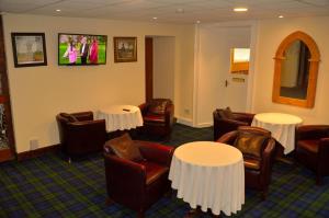 a hotel room with tables, chairs, and tables at Spean Bridge Hotel in Spean Bridge