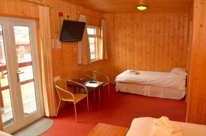 A bed or beds in a room at Spean Bridge Hotel