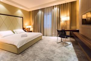 a hotel room with a bed and a desk at Monte Bianco Hotel & SPA in Astana