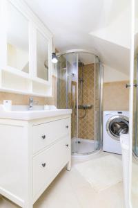 a bathroom with a sink and a washing machine at Holiday Home Obrov in Kaštela