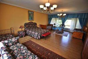 a living room with a bed and a couch at Casa Cunha in Cornanda