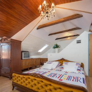 a bedroom with a large bed and a chandelier at Apartment Patricia in Trogir