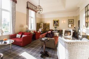 a living room with couches and chairs at Langrish House in Petersfield