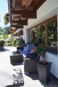 a patio with couches and a potted plant at Appartement Gästehaus Aloisia in Hippach