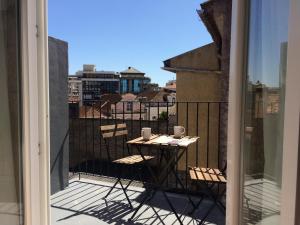 a table on a balcony with a view of a city at Casa Amarela in Aveiro