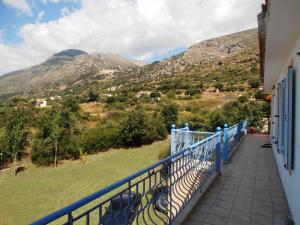 a balcony of a house with a view of mountains at M&L Studios in Valeriános