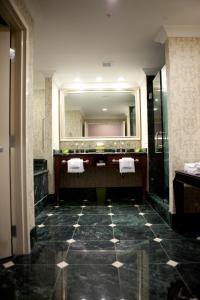 a bathroom with a large mirror and a sink at Town & Country Inn and Suites in Charleston