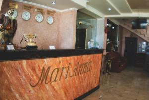 a bar in a restaurant with clocks on the wall at Marianna in Adler