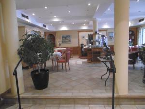 a living room with a table and a dining room at Hôtel La Flore in Villefranche-sur-Mer