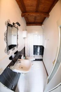 a bathroom with a sink and a mirror at Fattoria Il Santo in Santo