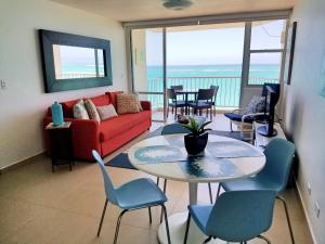 a living room with a couch and a table and chairs at Marbella del Caribe 1608 in San Juan