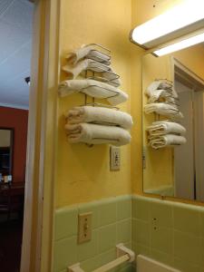 a bathroom with a rack of towels on a wall at Mount Vernon Inn in Sumter