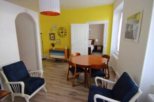 a dining room with a table and chairs at Le Jules in Colmar +8 photos