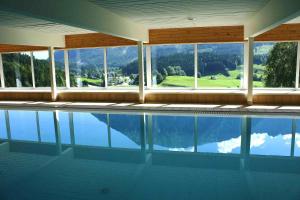a swimming pool with a view of the mountains at Appartement Bergblick in Tauplitz