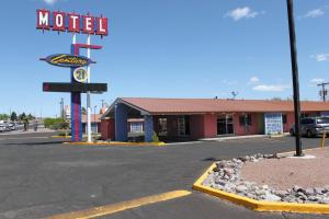a motel sign in front of a parking lot at Century 21 Motel in Las Cruces