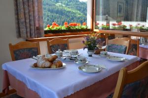 a table with a plate of food on it at Meublè Rosalpina in Valdidentro