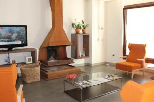 a living room filled with furniture and a fire place at Albergue Guiana in Ponferrada