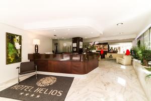 a lobby of a hotel with a reception desk at Hôtel Hélios in Juan-les-Pins