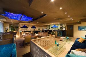 a living room with blue lights on the ceiling at Hôtel Hélios in Juan-les-Pins