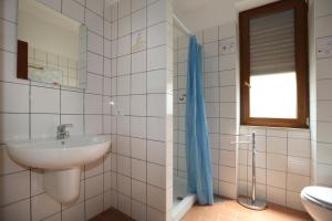 a bathroom with a sink and a toilet and a window at Casa Il Coccio in Sorrento