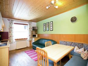 a living room with a table and a couch at Wonderful holiday home with mountain views in Altenmarkt im Pongau