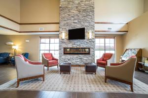 a waiting room with chairs and a fireplace at Comfort Suites Moab near Arches National Park in Moab