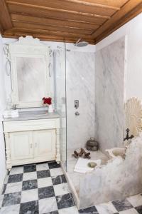 a bathroom with a glass shower and a sink at Terrace Houses Sirince in Selçuk