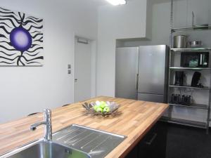 a kitchen with a sink and a wooden counter top at Luxurious countryside holiday home with pool in Malmedy