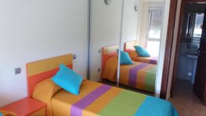 a bedroom with two beds and a mirror at Viva Cruce de Arinaga in Arinaga