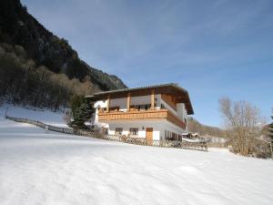 a building in the snow with a snow covered field at Apartment in St Gallenkirch near Ski Slopes in Sankt Gallenkirch