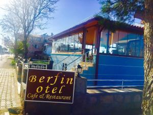 a sign in front of a restaurant with a boat at Berfin Otel in Dalyanköy