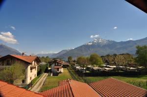 a view of a village with mountains in the background at North Wind Camping & Apartment in Domaso