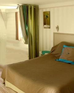 
a bedroom with a bed and a lamp at Chambres d'Hôtes Les Tilleuls in Sarlat-la-Canéda
