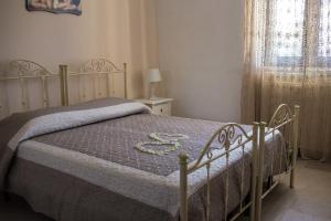 a bedroom with a bed with a blue comforter at Residenze nei Trulli in Alberobello