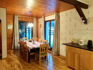 a kitchen and dining room with a table and chairs at Chalet with mountain views in Laffrey