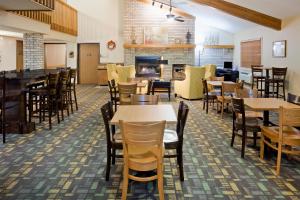 a dining room with tables, chairs, and tables at AmericInn by Wyndham Ironwood in Ironwood