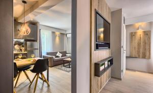 a living room and a living room with a table and a couch at Apartment Mondo Deluxe in Kaštela +20 photos