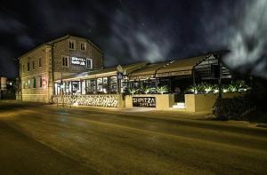 a building with lights on the side of a street at Apartment Mondo Deluxe in Kaštela