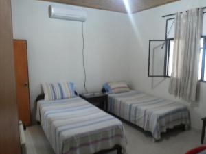 a room with two beds and a window at Hotel Orinoco Real in Inírida