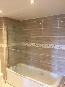 a bathroom with a shower and a bath tub at Newcastle Executive Apartment in Newcastle upon Tyne