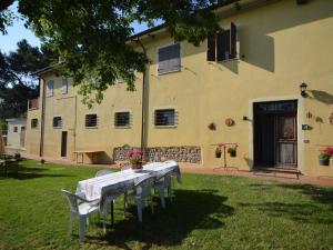 una mesa y sillas frente a un edificio en Lovely Holiday Home with Pool in Monte Colombo, en Monte Colombo