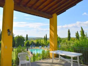 a patio with a table and chairs and a pool at Belvilla by OYO Da Vinci Due in Vinci