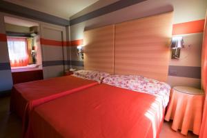 Ein Bett oder Betten in einem Zimmer der Unterkunft Hotel Villamare