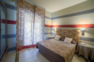 Ein Bett oder Betten in einem Zimmer der Unterkunft Hotel Villamare