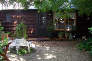 a house with a bench in front of a door at Madam Saddler - On Fraser Clunes in Clunes