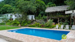 a swimming pool in the yard of a house at Santval Lodge in Bucay