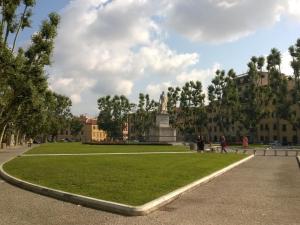 a park with people walking on the grass at Pisa Stay close to Leaning Tower in Pisa